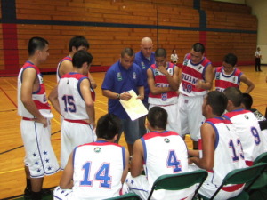 Sid Guzman discuss game plan with the team
