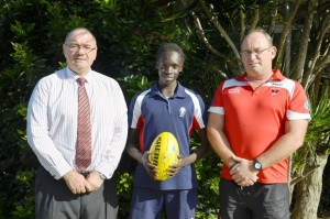 Bishop Druitt College student Kaman Malou will be representing NSW/ACT in the All Nations Cup to be played in Coffs Harbour. Kaman is pictured with school principal Alan Ball and AFL Northern NSW regional manager Rb McKelvie. Photo: Brad Palmer - Bishop D