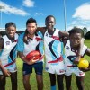 KING OF THE KIDS: Former Carlton and GWS Giants player Setanta Ó hAilpín with All Nations Cup players Blaise Singizwa (Kenya), Kaman Malou (South Sudan) and James Demby (Sierra Leone). Photo: Trevor Veale/Coffs Coast Advocate