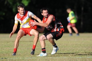 Sawtell/Toormina midfielder Luke Benson tries to escape the close attention of his Coffs Swans opponent at Fitzroy Oval. Photo: Leigh Jensen / Coffs Coast Advocate