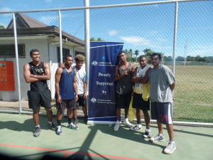 3x3 participants posing by sponsors banner